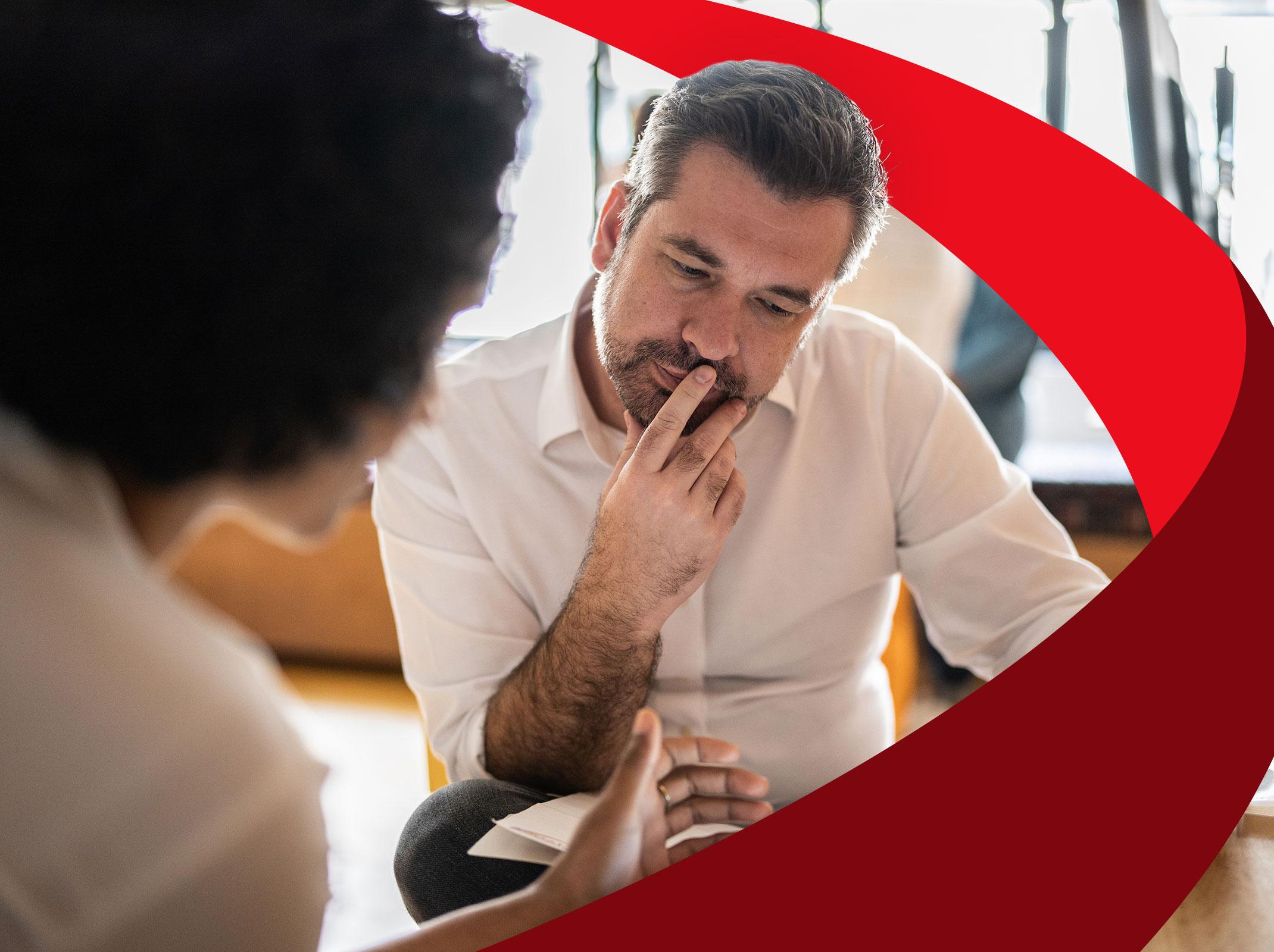 Intelligent man using innovation techniques to solve a problem with a coworker
