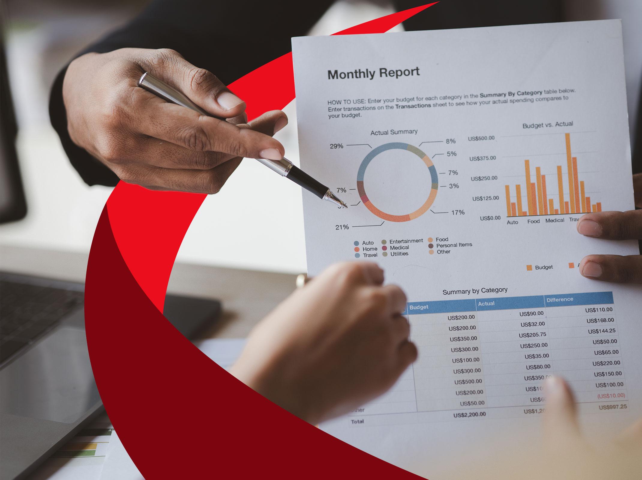 Business professional sharing financial data on a report with another business professional.
