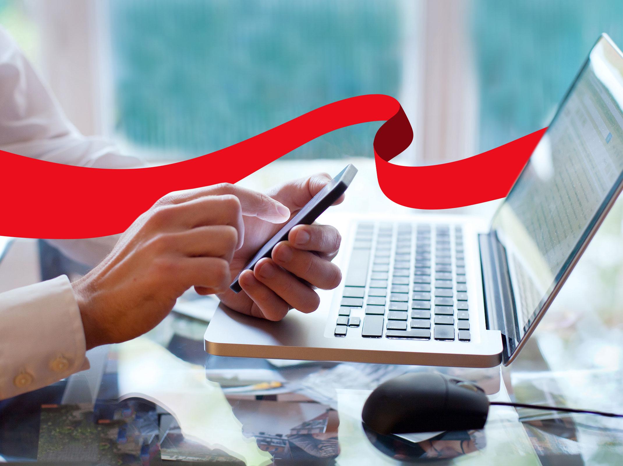 Business professional working on a laptop and phone