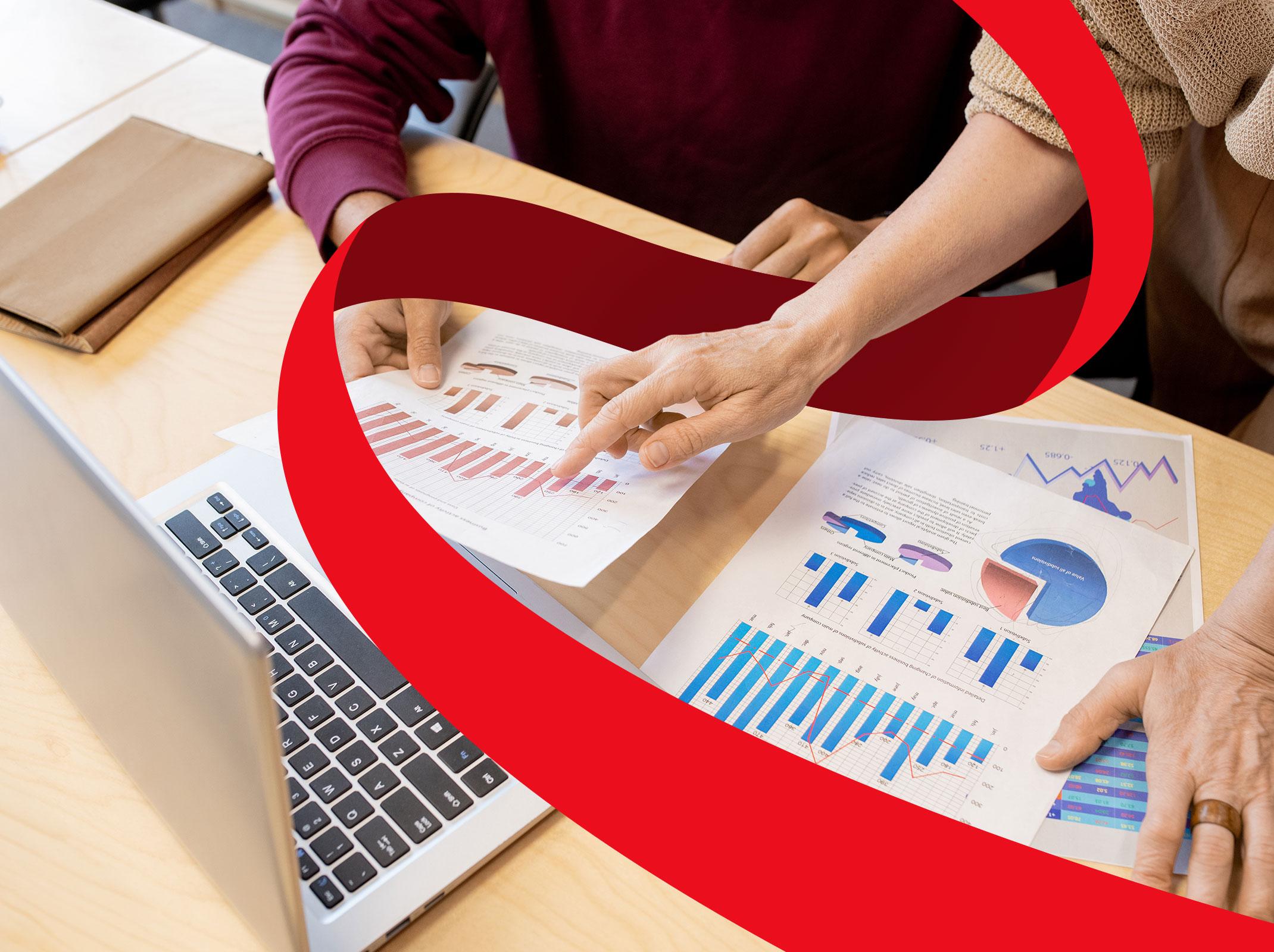 Coworkers reviewing charts and graphs from Microsoft Excel